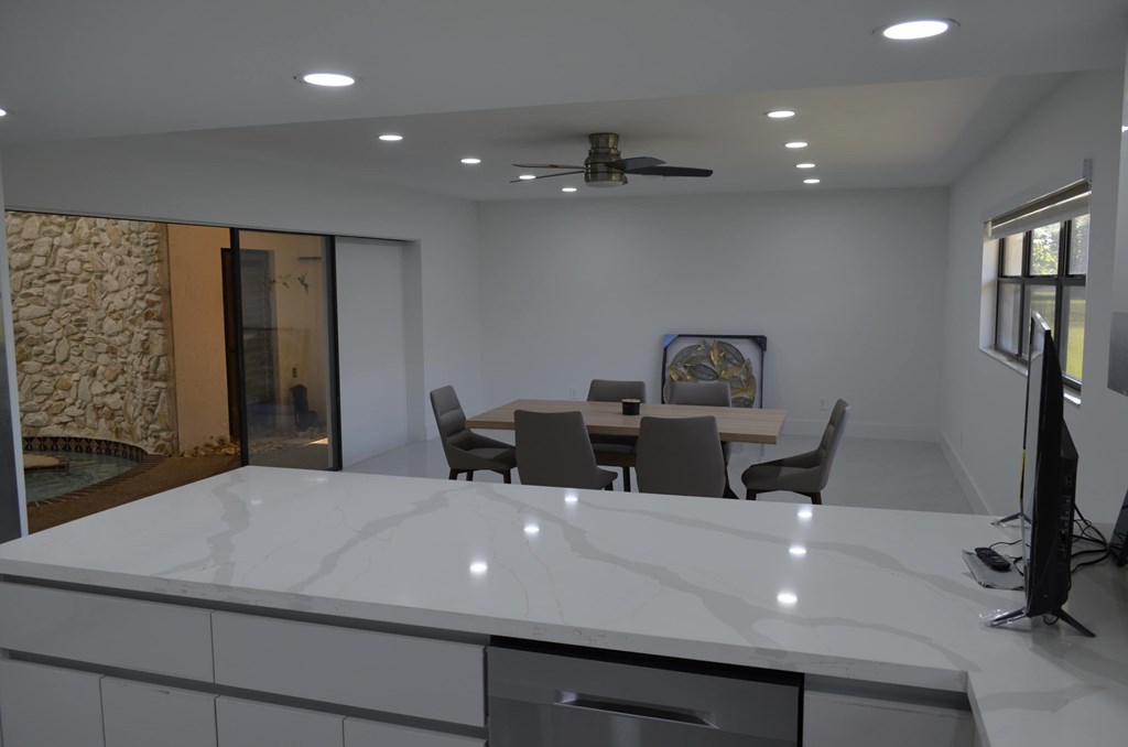 A modern kitchen with a dining table and chairs.