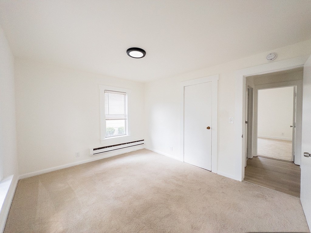 A white bathroom with a sink, toilet and bathtub.