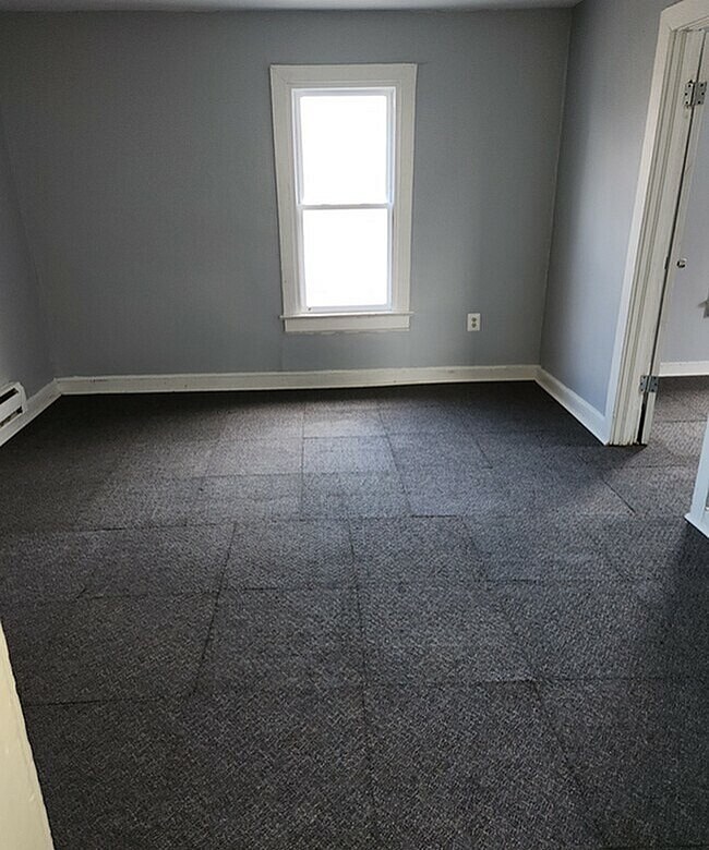 A room with a window and a door.