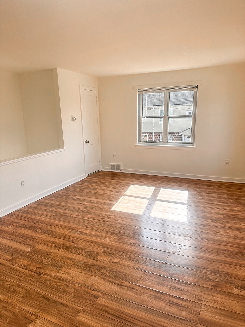 A room with grey walls and a window with a white frame.