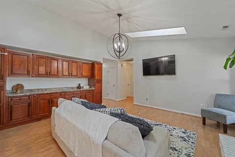 A living room with a couch and a television.