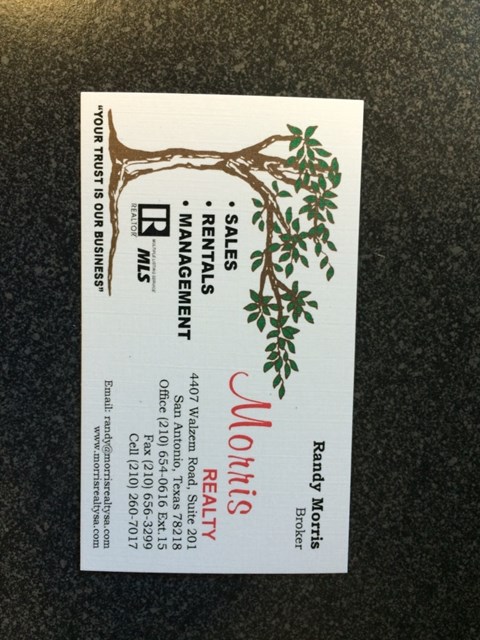 A business card for a realtor with a tree design on it.