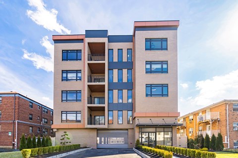A modern apartment building with a mix of brick and panel facades.