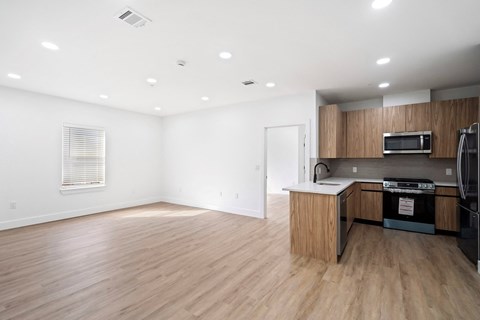 A kitchen area with a microwave, oven, and refrigerator.