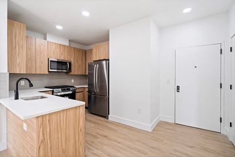 A kitchen with wooden cabinets and stainless steel appliances.