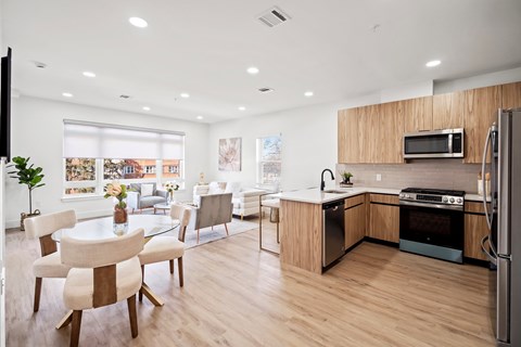 A modern kitchen with a dining table and chairs.