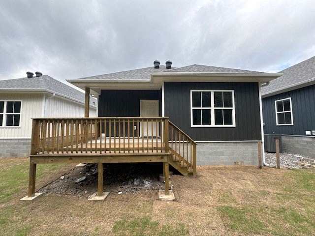 A house with a grey roof and a wooden deck.