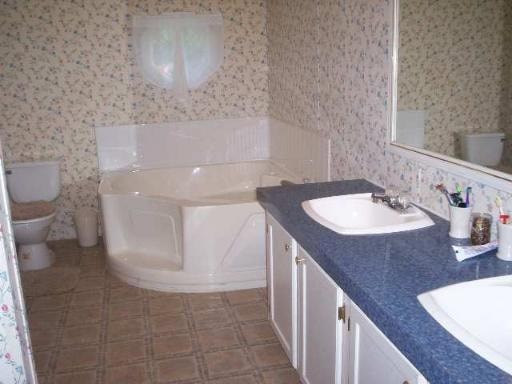 A bathroom with a blue counter top and a white sink.