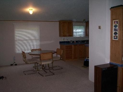 A kitchen with a table and chairs.