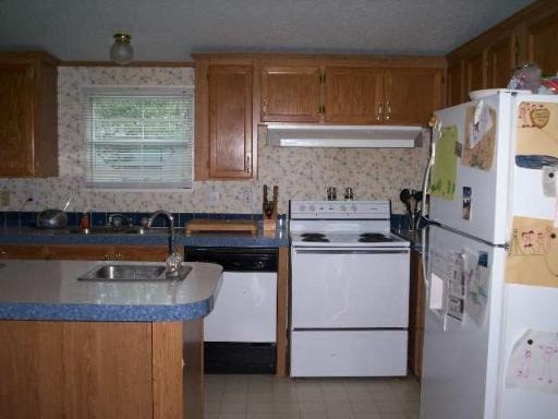 A kitchen with a white fridge and a white stove.