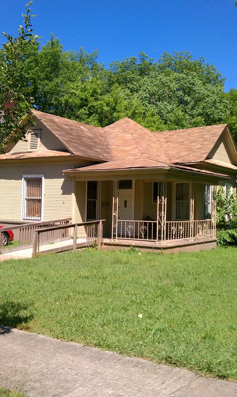 A house with a brown roof and a porch.