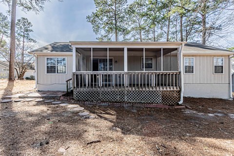 A house with a porch and a screened-in area.