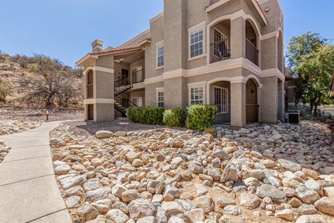 A house with a stone pathway in front of it.