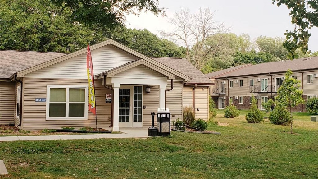 A small building with a flag in front of it.