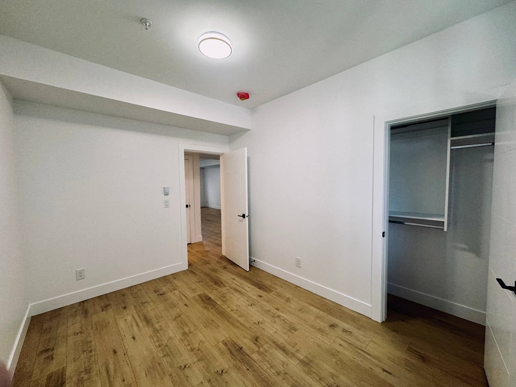 A room with wooden floors and white walls.