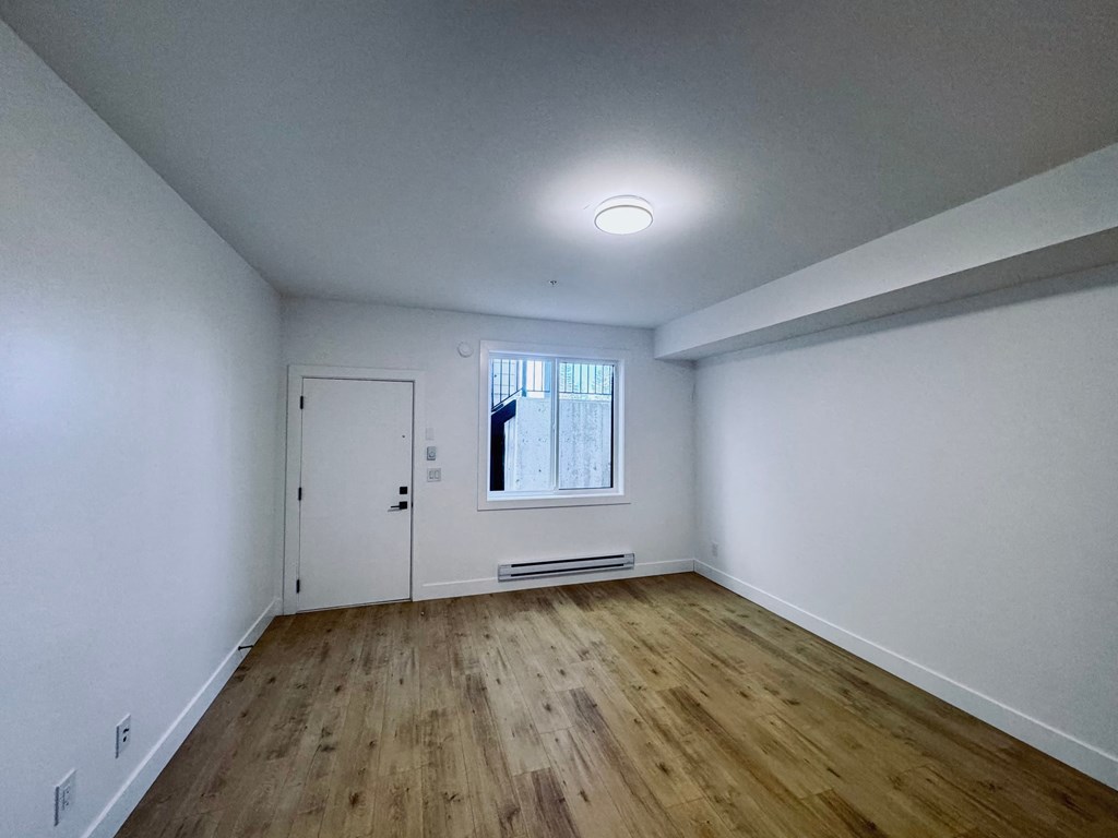 A room with wooden floors and white walls.
