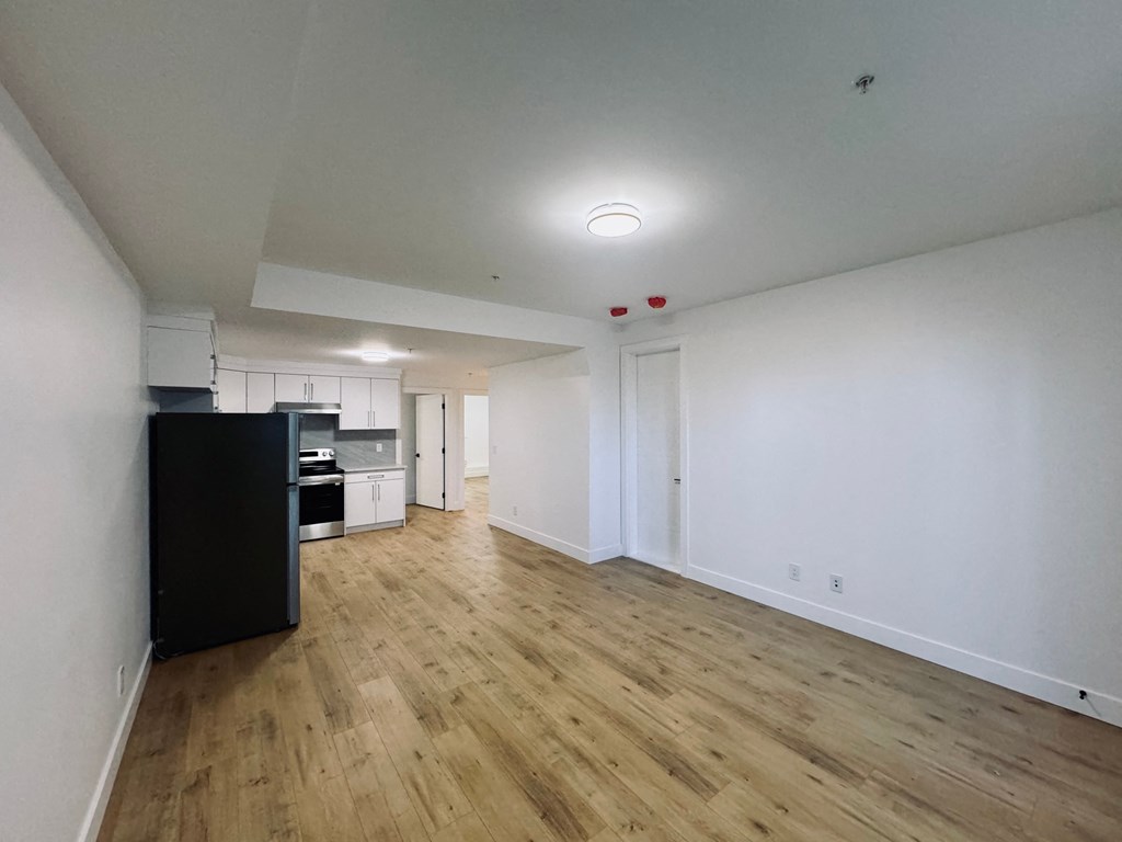 A room with wooden floors and white walls.