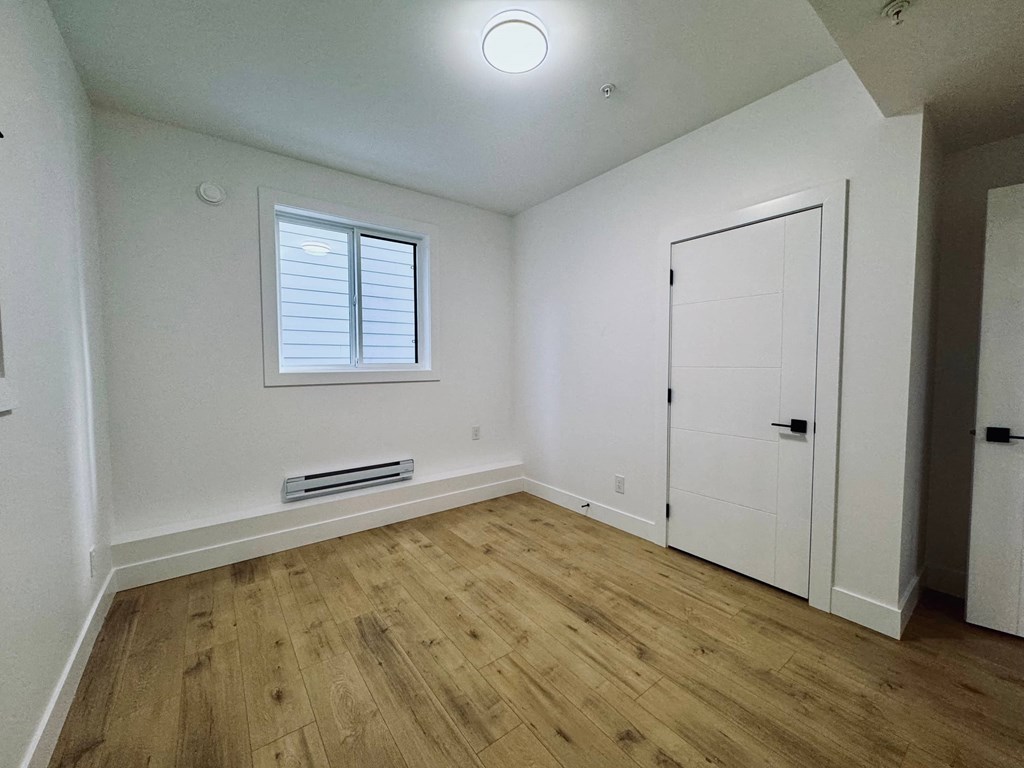 A room with wooden floors and white walls.