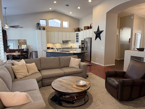 A modern living room with a grey sectional sofa and a wooden coffee table.