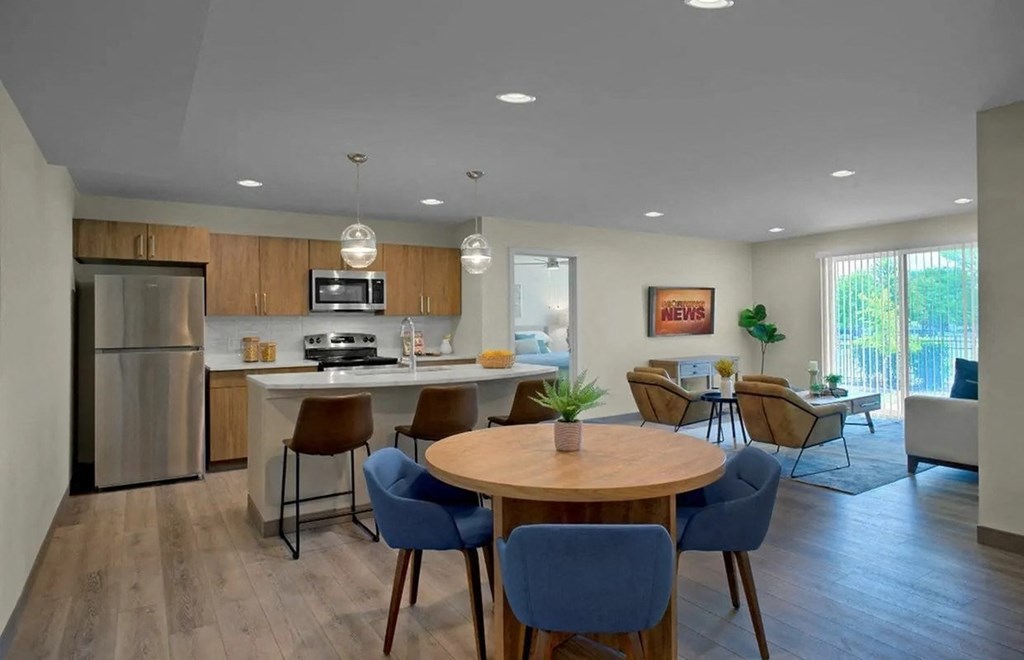 A modern kitchen with a dining table and chairs.