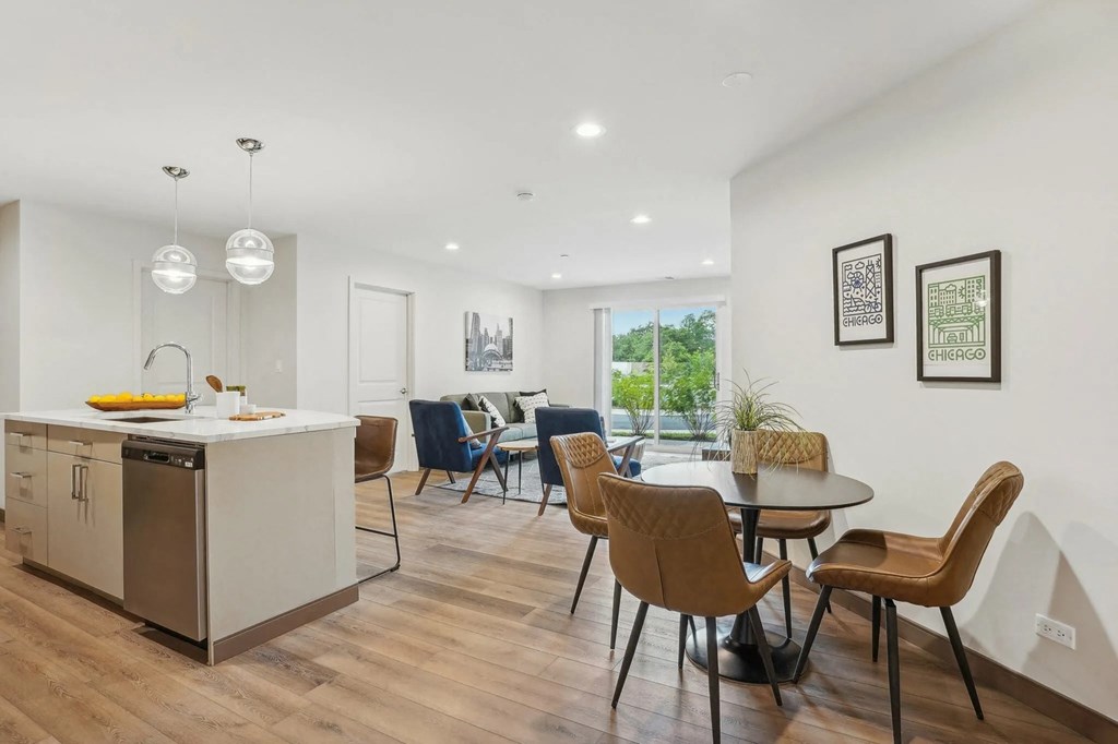 A modern kitchen with a dining table and chairs.