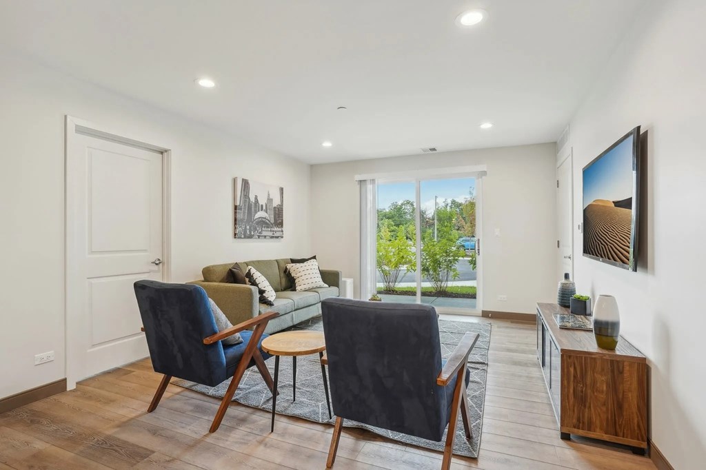 A living room with a blue chair and a green couch.
