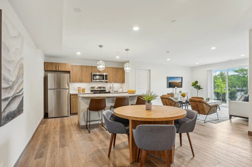 A modern dining room with a wooden table and chairs.