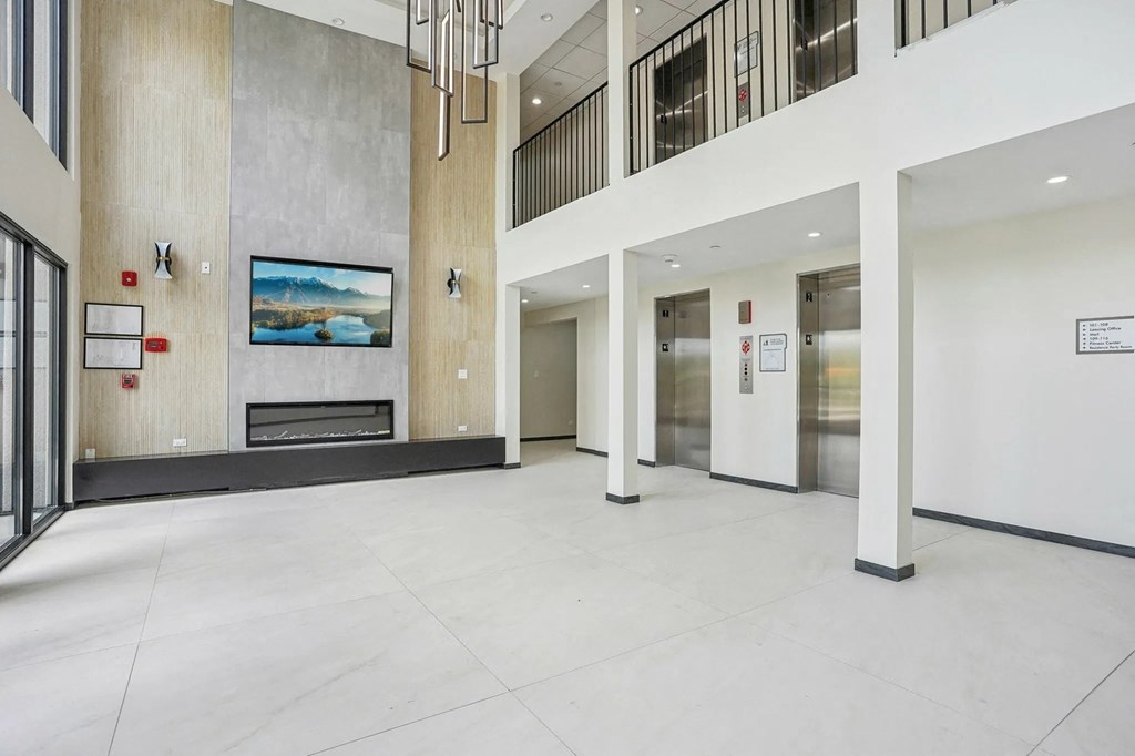 A modern hallway with a fireplace and a painting on the wall.
