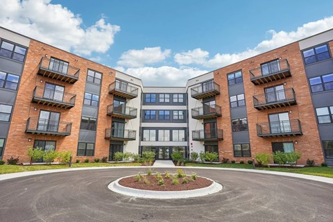 A roundabout leads to a building with a white and black facade.