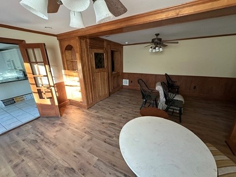 A living room with a white table and chairs.