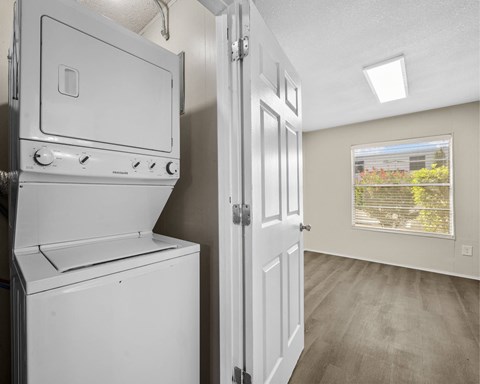 A white oven and stove in a kitchen with a door open.