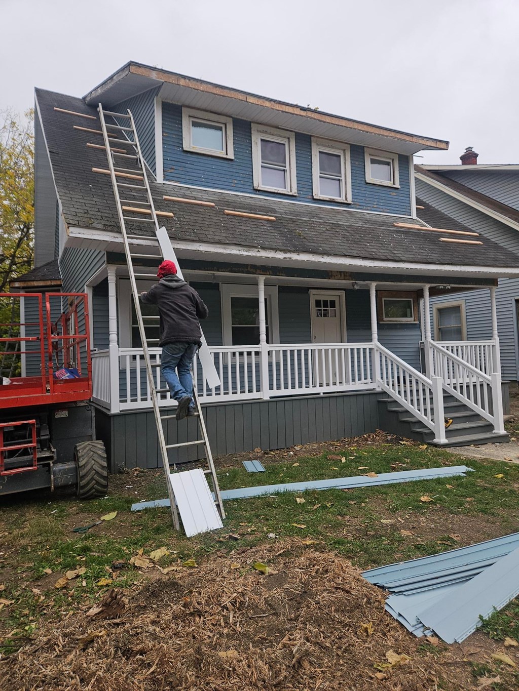A man is painting the exterior of a house.