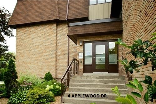 A building with a glass door and a sign that says 4 Applewood Dr.