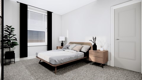 A bedroom with a bed, nightstand, and a plant.