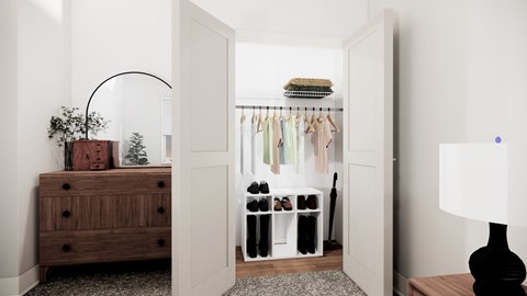 A room with a wooden chest of drawers, a lamp, and a closet with clothes.