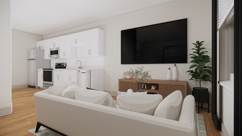 A modern living room with a white sofa and a television mounted on the wall.