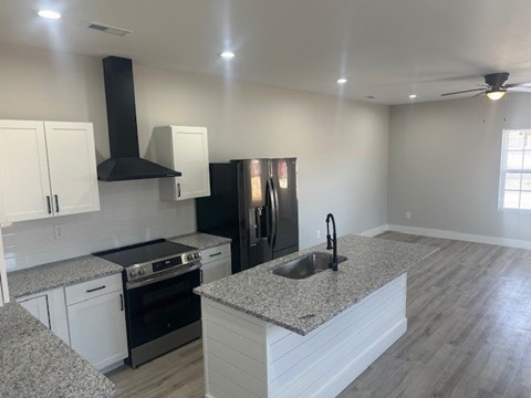 A kitchen with granite countertops and stainless steel appliances.