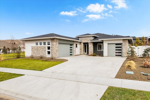 A modern house with a stone pillar entrance.