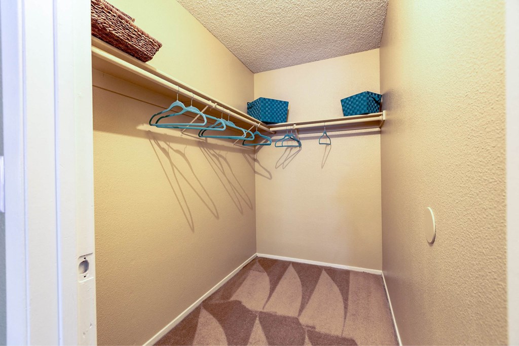 A hallway with a white door and a wall with a patterned carpet.