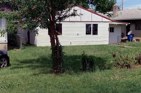 A white house with a red stripe on the roof.