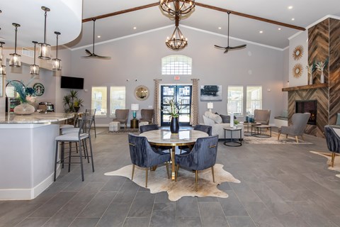 A modern living room with a bar area and a dining table.