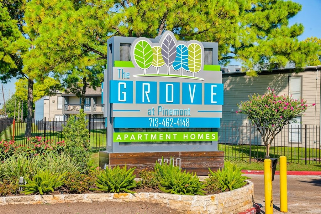A sign for The Grove apartment homes at Flinnent with a phone number on it.