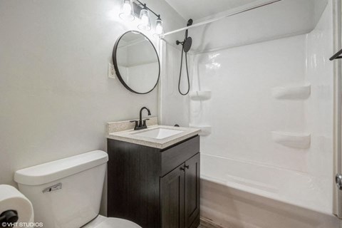 A white toilet sits next to a sink in a bathroom.