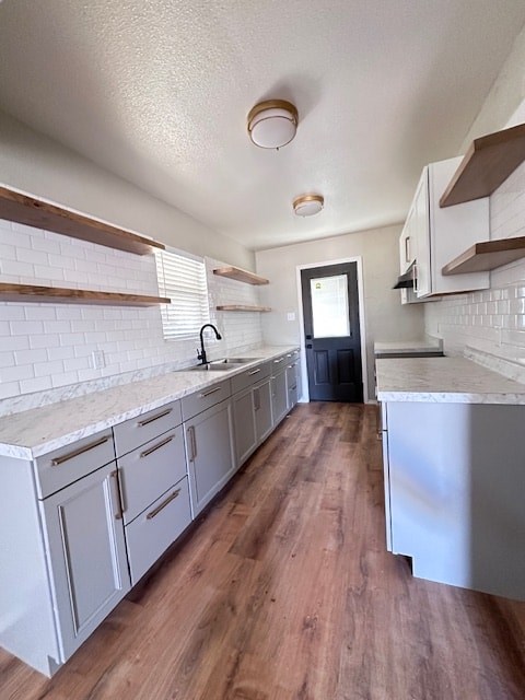 A kitchen with white cabinets and a white counter top.