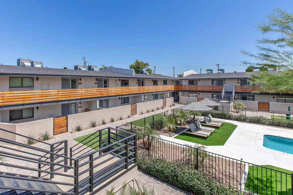 A view of a pool and a fence in front of a building.