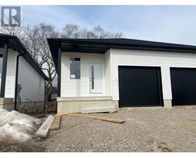 A two-story house with a garage door and a door on the ground floor.