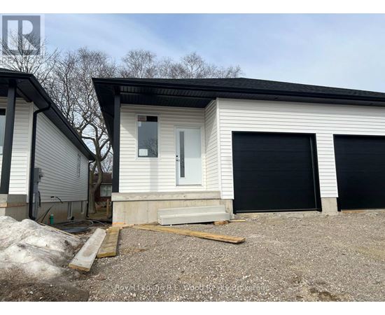 A two-story house with a garage door and a door on the ground floor.