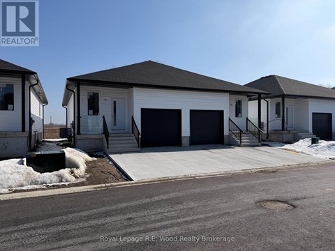 A two-story house with a garage door and a door on the ground floor.