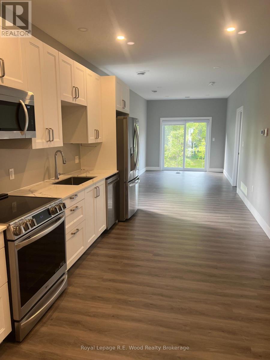 A kitchen with white cabinets and stainless steel appliances.