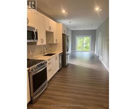 A kitchen with white cabinets and stainless steel appliances.